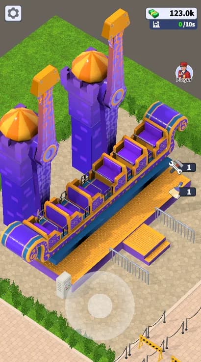 A magic-carpet ride already in Theme Park Manager: purple and gold ornamented towers with domed caps, individual seats along the carpet, boarding platform and queue rails, seen through the game's elevated diagonal camera