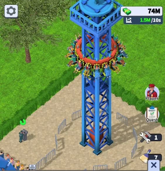 The Drop Tower mid-cycle in Theme Park Manager: the seat ring loaded with riders has climbed partway up the blue lattice mast, with guests visible in every seat